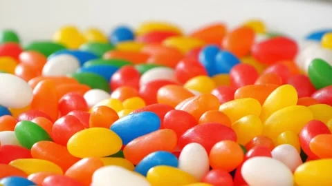 Multicolor Jelly Beans Candy Falls on White Background. Bright Tasty Colourful Video stock 142524112