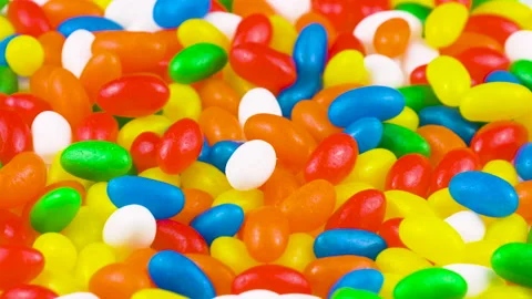 Multicolor Jelly Beans Candy Rotating Background. Bright Tasty Colourful Texture Stock Footage 141334144