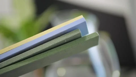 Multicolor knife sharpening stones close up grinding sound blade contact detail Stock Footage 320896490