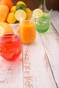 Multicolor mocktails with ice. Cherry mocktail, limon mocktail on wooden surf Stock Photos