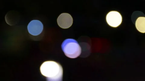 Multicolor moving defocused bokeh lights on a dark background, beautiful bokeh b Stock Footage 217375981