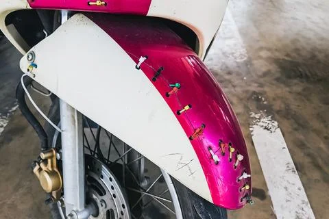 Multicolor nylon cable ties mounting on front broken motorcycle or scooter .. Stock Photos