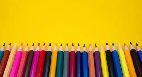 Multicolor Pencils on Yellow Background Stock Photos