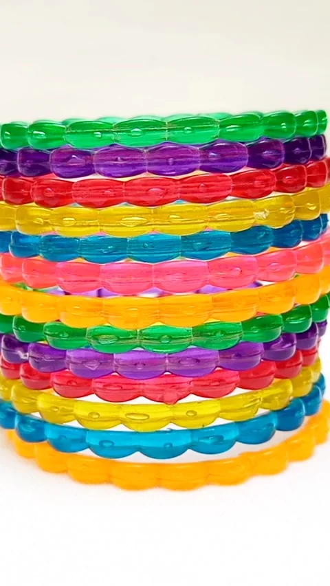 Multicolor plastic bangles set rotating on white background, fashion accessory Stock Footage 320669422