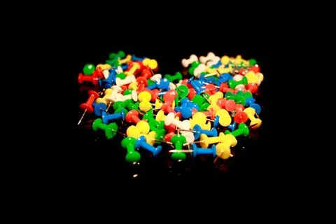 Multicolor Plastic Head Push Pins Thumbtacks isolated on black with reflectio Stock Photos