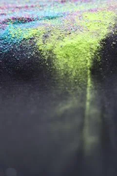 Multicolor powder explosion on black background. Colorful dust explode. Paint Stock Photos