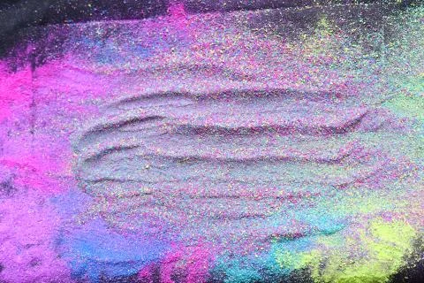 Multicolor powder explosion on black background. Colorful dust explode. Paint Foto stock