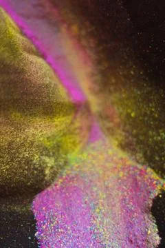 Multicolor powder explosion on black background. Colorful dust explode. Paint Foto stock