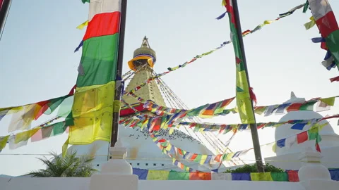 Multicolor prayer flags flutter near golden white festive Swayambhunath stupa Stock Footage 167490734