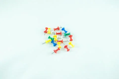 Multicolor pushpins on white background. Isolated Stock Photos