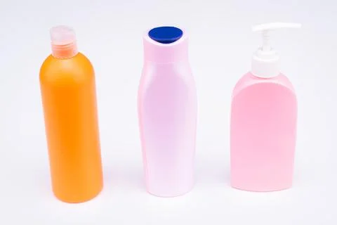 Multicolor refillable flip cap and pump cosmetic product packaging in row Stock Photos