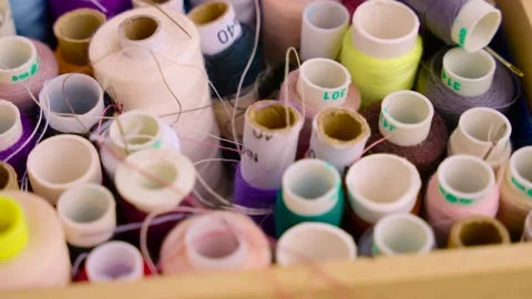 Multicolor sewing spools threads lie in wooden box. shooting detail object Stock Footage 329282021