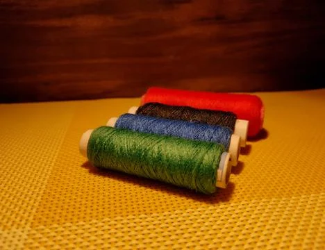 Multicolor sewing threads with dark background. Stock Photos