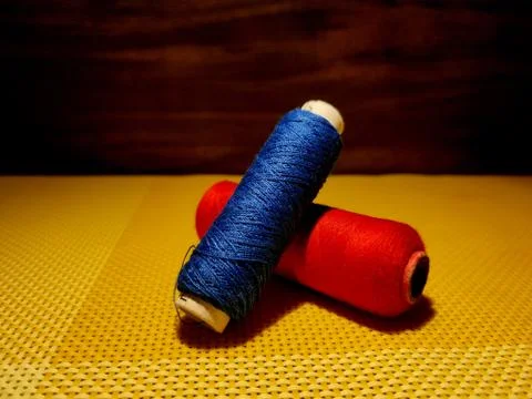 Multicolor sewing threads with dark background. Stock Photos