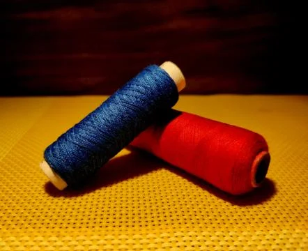 Multicolor sewing threads with dark background. Stock Photos