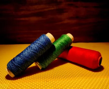 Multicolor sewing threads with dark background. Stock Photos