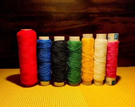Multicolor sewing threads with dark background. Stock Photos