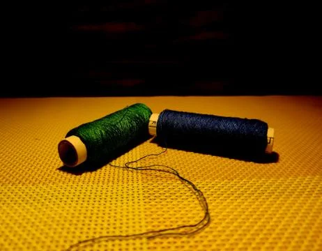 Multicolor sewing threads with dark background. Stock Photos