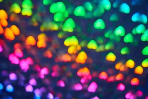 Multicolor space blurred three-dimensional heart-shaped bokeh, neon juicy bri Stock Photos