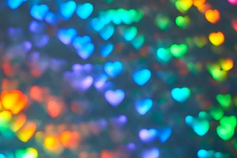 Multicolor space blurred three-dimensional heart-shaped bokeh, neon juicy bri Stock Photos