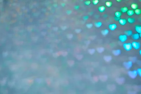 Multicolor space blurred three-dimensional heart-shaped bokeh, neon juicy bri Stock Photos