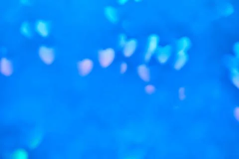 Multicolor space blurred three-dimensional heart-shaped bokeh, neon juicy bri Stock Photos