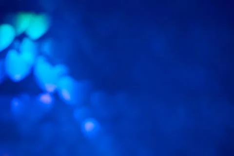 Multicolor space blurred three-dimensional heart-shaped bokeh, neon juicy bri Stock Photos