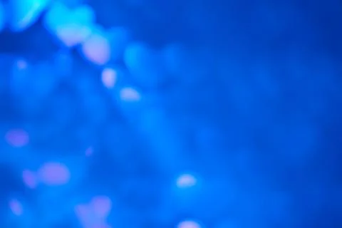 Multicolor space blurred three-dimensional heart-shaped bokeh, neon juicy bri Stock Photos