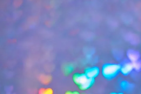 Multicolor space blurred three-dimensional heart-shaped bokeh, neon juicy bri Stock Photos