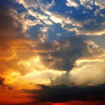 Multicolor sunset sky with clouds and sun rays Stock Photos