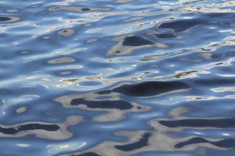 Multicolor waves of the summer river Stock Photos