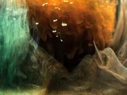 Multicolored abstract background. Orange, brown and green ink mixing in water. Stock Photos