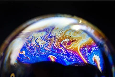 Multicolored abstract chaotic pattern inside of the soap bubble, closeup M... Stock Photos