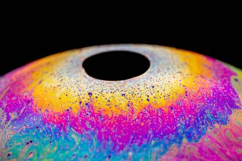 Multicolored abstract chaotic pattern inside of the soap bubble, closeup M... Foto stock