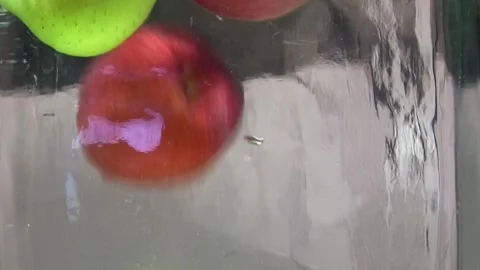 Multicolored apples fall into the water Stock Footage 291104874