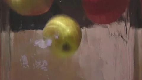 Multicolored apples falling into water close-up Stock Footage 291104755