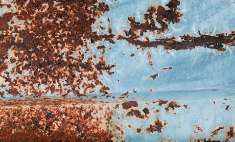 Multicolored background: rusty metal surface with blue paint flaking and crac Stock Photos
