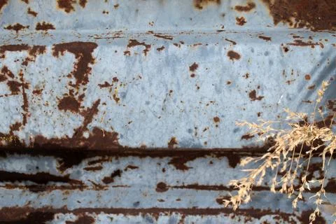 Multicolored background: rusty metal surface with blue paint flaking and crac Stock Photos