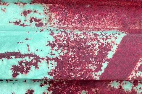Multicolored background: rusty metal surface with blue paint flaking and crac Stock Photos