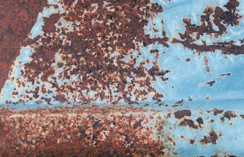 Multicolored background: rusty metal surface with blue paint flaking and crac Stock Photos