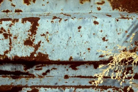 Multicolored background: rusty metal surface with blue paint flaking and crac Stock Photos