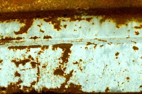 Multicolored background: rusty metal surface with blue paint flaking and crac Stock Photos
