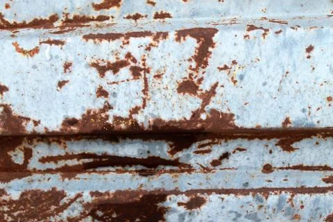 Multicolored background: rusty metal surface with blue paint flaking and Stock Photos