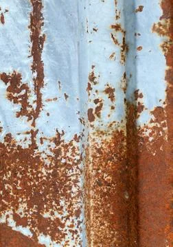Multicolored background: rusty metal surface with blue paint flaking and Stock Photos