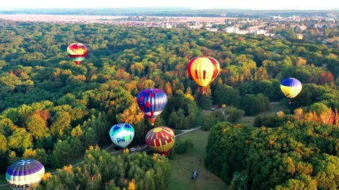 Multicolored balloons fly over trees. Nice top view of the park. Stock Footage 168803177