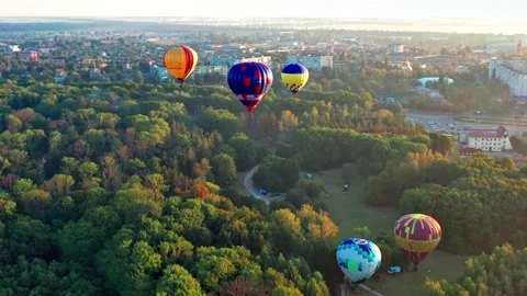 Multicolored balloons fly over trees. Nice top view of the park, forest cover Stock Footage 169357056
