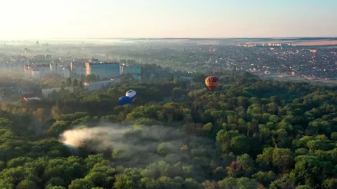 Multicolored balloons fly over trees. Nice top view of the park. Stock Footage 195622386