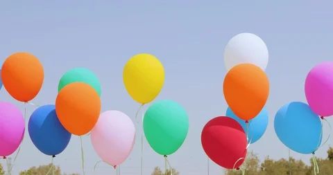 Multicolored balloons moves at wind on the sky background Stock Footage 128822046