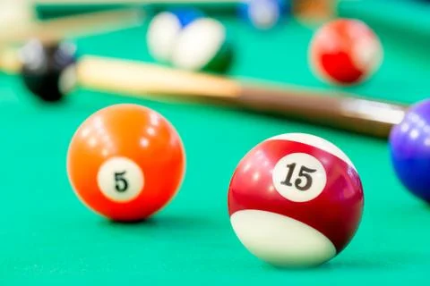 Multicolored balls on green baize of billiard Stock Photos