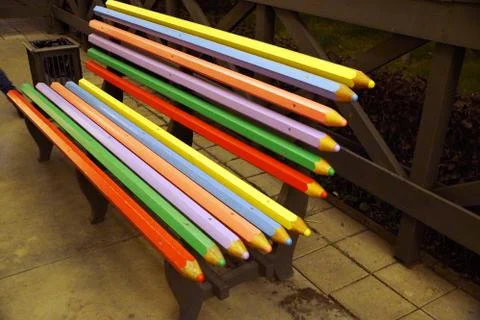 Multicolored bench made of boards in the form of colored pencils Stock Photos